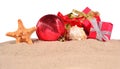 Christmas decorations seashells and starfish on a beach sand on Royalty Free Stock Photo