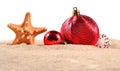 Christmas decorations seashells and starfish on a beach sand on Royalty Free Stock Photo