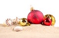 Christmas decorations seashells and starfish on a beach sand Royalty Free Stock Photo