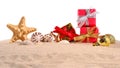 Christmas decorations seashells and starfish on a beach sand on Royalty Free Stock Photo