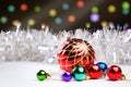 Christmas decorations and silver defocused tinsel on a dark background with blurred lights Royalty Free Stock Photo