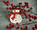 Christmas decorations snowman, red berries on wooden background Royalty Free Stock Photo