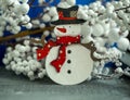 Christmas decorations snowman, red berries on wooden background Royalty Free Stock Photo