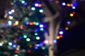 Blurred golden garland on Christmas tree, defocused background. Christmas abstract Royalty Free Stock Photo