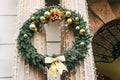 A traditional Christmas wreath decorates the columns of the building. Royalty Free Stock Photo