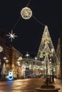 Christmas decorations on streets of city. Illumination of bright decorative elements in evening light in St. Petersburg