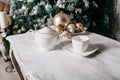 Christmas decorations on the table against the background of a fireplace decorated with branches spruce and garland. Royalty Free Stock Photo