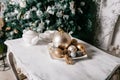 Christmas decorations on the table against the background of a fireplace decorated with branches spruce and garland. Royalty Free Stock Photo