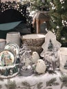 Christmas decorations in a shop window in white, green and gray colors with reindeers, birds, tableware and snow ball Royalty Free Stock Photo