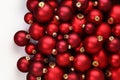 Christmas decorations, top view of pile of glass balls colored in red, isolated on white background, useful as a greeting gift Royalty Free Stock Photo