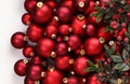 Christmas decorations, top view of pile of glass balls colored in red and mistletoe, isolated on white background, useful as a Royalty Free Stock Photo