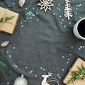Christmas decorations, tree branch, snowflakes, coffee cup and gifts on gray texture. Flat lay, top view. Christmas frame Royalty Free Stock Photo