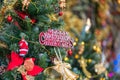 Christmas decorations on a christmas tree with Merry Christmas sign hanging on tree Royalty Free Stock Photo