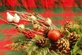 CHRISTMAS DECORATIONS, two white doves, gold jingle bells, pine cones, evergreen branches, red and green Royalty Free Stock Photo