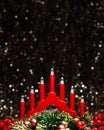 Christmas decorations view of red candle lights bridge, red berries and Christmas green round wreath colored in gold at the tips Royalty Free Stock Photo