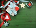 Christmas decorations on vintage green wood background, with silver gift. Royalty Free Stock Photo