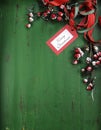 Christmas decorations on vintage green wood background. Vertical with Merry Christmas tag.