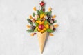 Christmas decorations in waffle ice cream cone with fir branches, tangerine fruits and decorations. top view. flat lay