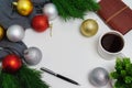 Christmas decorations on white background with coffee and diary.