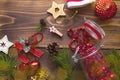 Christmas decorations on a wooden background. Beads in a glass jar with a lid, stars, Santa hat, cones, pine branches. New year, p Royalty Free Stock Photo