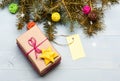 Christmas decorations wooden background top view. Present box and gift tag copy space. Winter time and christmas Royalty Free Stock Photo