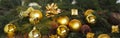 Christmas decorations yellow balls, fir branches on a wooden background with copy space. Gold style. Royalty Free Stock Photo