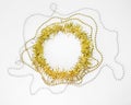 Christmas decorations of yellow and golden color on a white background - chain of balls, beads, round circle of tinsel. New year Royalty Free Stock Photo