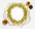 Christmas decorations of yellow and golden color on a white background - chain of balls, beads, round circle of tinsel,three bumps Royalty Free Stock Photo