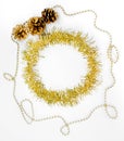 Christmas decorations of yellow and golden color on a white background - chain of balls, beads, tinsel, three bumps. New year Royalty Free Stock Photo