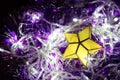 Christmas Decorations: Yellow Star Ornament for Christmas Tree with White Lights and Purple Boas Royalty Free Stock Photo