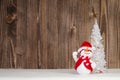 Christmas decorative snowman on the dark wooden background.