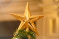 A Christmas decorative - star on the top of A Christmas tree with a beautiful bokeh Royalty Free Stock Photo