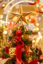 A Christmas decorative - star on the top of A Christmas tree with a beautiful bokeh background Royalty Free Stock Photo