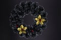 Christmas decorative wreath with golden floral top view on black background. Winter Holiday season backdrop Royalty Free Stock Photo