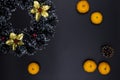 Christmas decorative wreath, pine and tangerines on black background. Winter Holiday season backdrop Royalty Free Stock Photo
