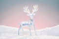 Christmas deer toy figurine in cold pastel light colors.