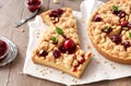 Christmas delicious Crumbly shortbread pie with plum and apple jam on wooden background