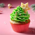 Christmas delicious cupcake with green whipped cream and star on pink background. Xmas homemade dessert