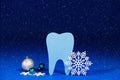 Christmas dentistry - tooth, snowflakes and balls on a blue festive background with snow Royalty Free Stock Photo