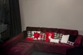 Christmas design cushions on an armchair in a house with a white wall in the background