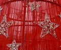 Christmas detail of a silver color star surrounded by red color Royalty Free Stock Photo