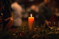 Christmas dinner with a burning candle in the middle and bokeh. Royalty Free Stock Photo