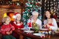 Christmas dinner. Family with kids at Xmas tree. Royalty Free Stock Photo