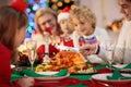 Christmas dinner. Family with kids at Xmas tree Royalty Free Stock Photo