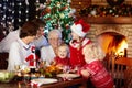 Christmas dinner. Family with kids at Xmas tree Royalty Free Stock Photo