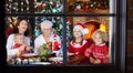 Christmas dinner. Family with kids at Xmas tree. Royalty Free Stock Photo