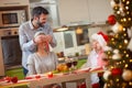 Christmas dinner- happy father and children surprises mother