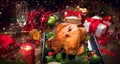 Christmas Dinner. Roasted chicken. Winter Holiday table served, decorated with candles and xmas baubles Royalty Free Stock Photo