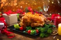 Christmas Dinner. Roasted chicken. Winter Holiday table served, decorated with candles and xmas baubles Royalty Free Stock Photo