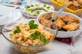 Christmas dinner table with vegetable salad and traditional fried carp fish Royalty Free Stock Photo